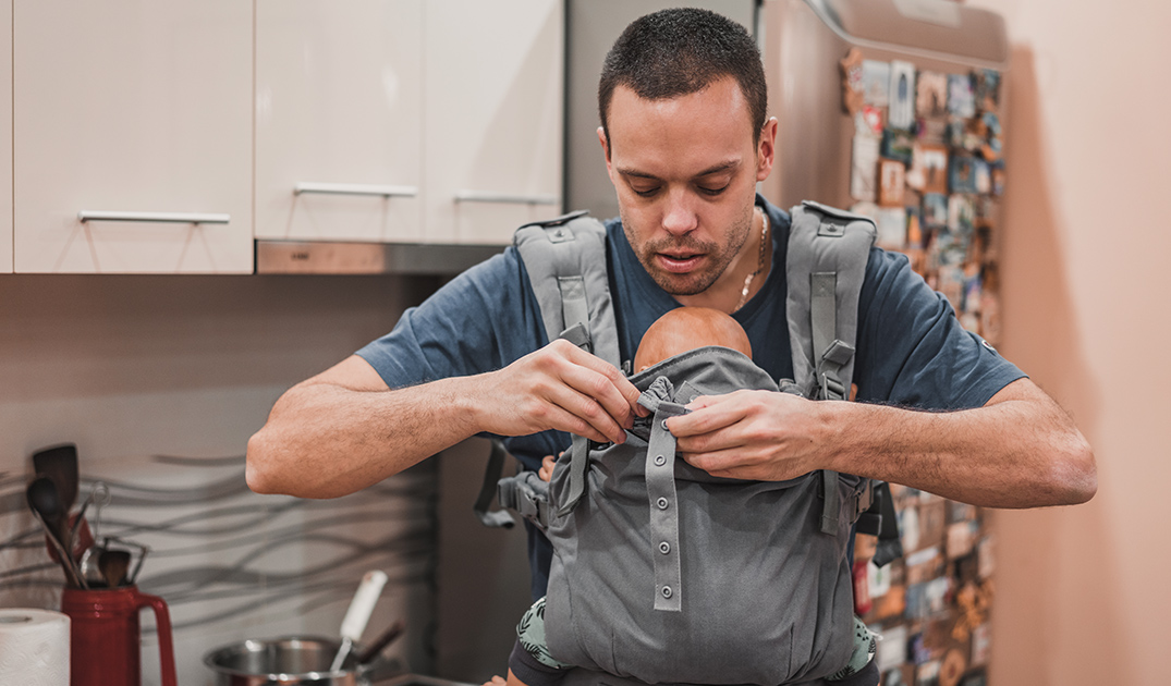 dad fixing baby carrier dad fixing baby carrier