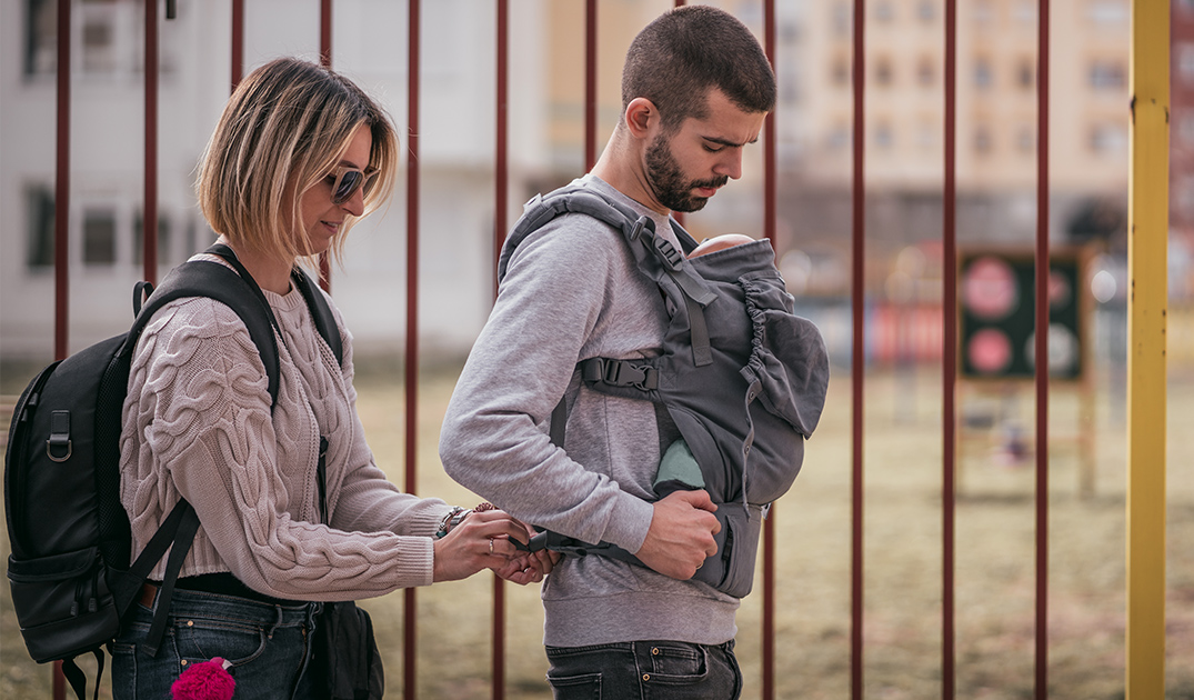 mom help dad to fix baby carrier