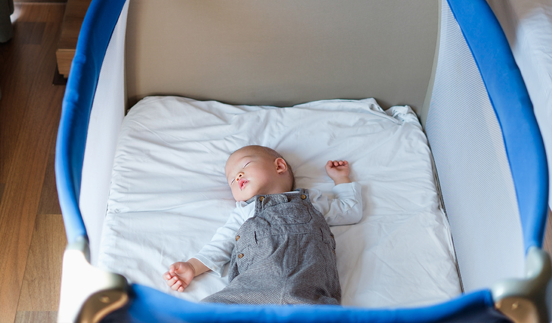 child sleeping in playard