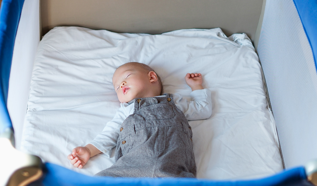 baby sleeping in playpen