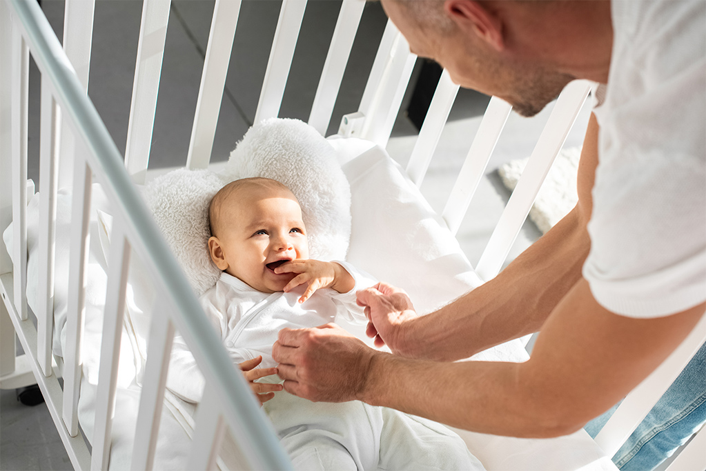 Baby in mini crib