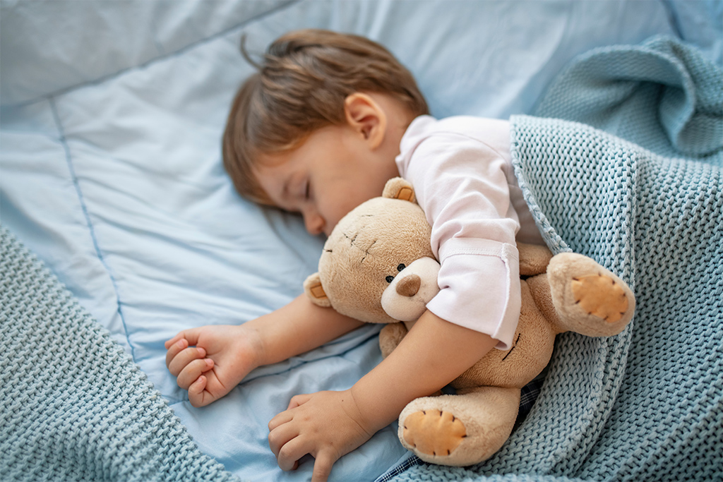 Baby sleeping in portable crib