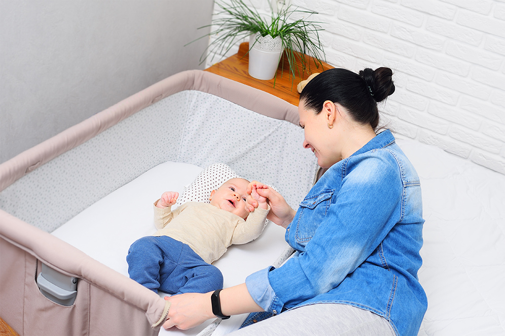 Mother with baby in bassinet